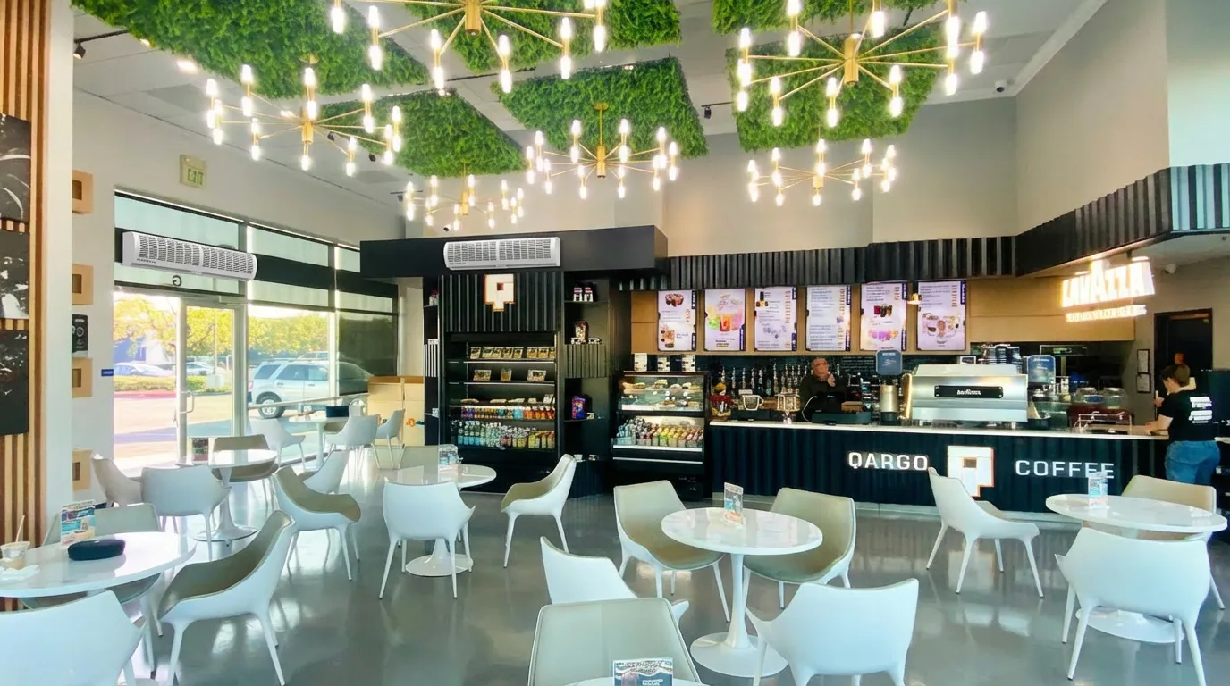 Commercial air curtain installed above a café entrance door to prevent outdoor air, dust, and insects while maintaining indoor comfort